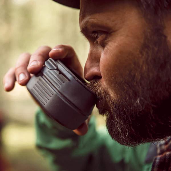 Man with a beard drinking from a Wildo Fold-A-Cup